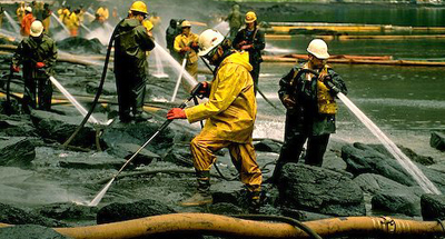 Oil spill workers attempt clean up of oiled shore line